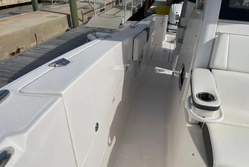 Slide: The Image of 2023 Robalo R360 Center Console boat interior with seating and cup holder. - 7