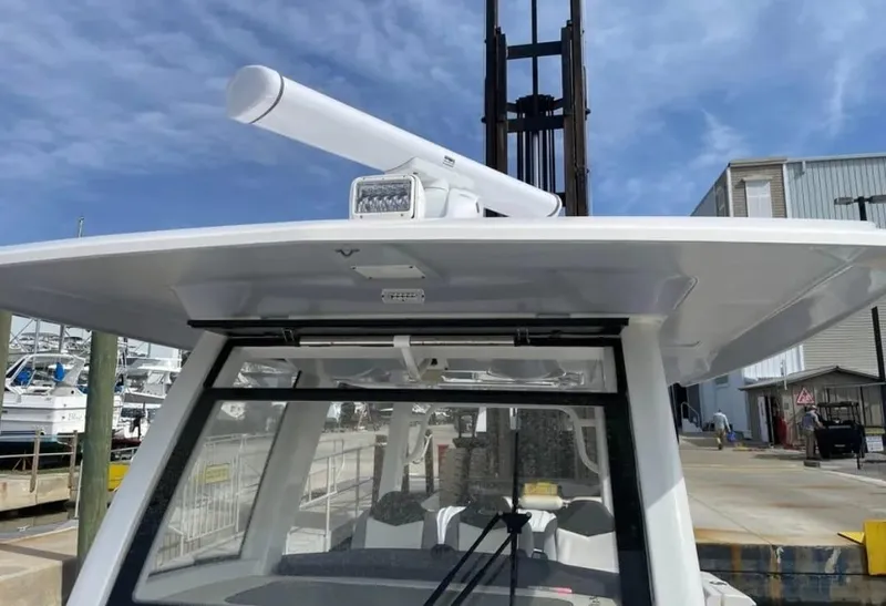 Slide: The Image of 2023 Robalo R360 Center Console boat with radar, docked at marina. - 9