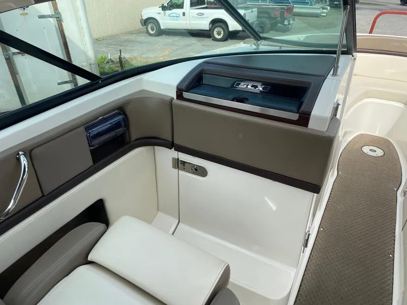Slide: The Image of 2013 Sea Ray 270 SLX boat interior with beige and brown seating. - 10