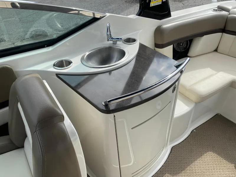 Slide: The Image of 2013 Sea Ray 270 SLX boat interior with compact marine toilet. - 12