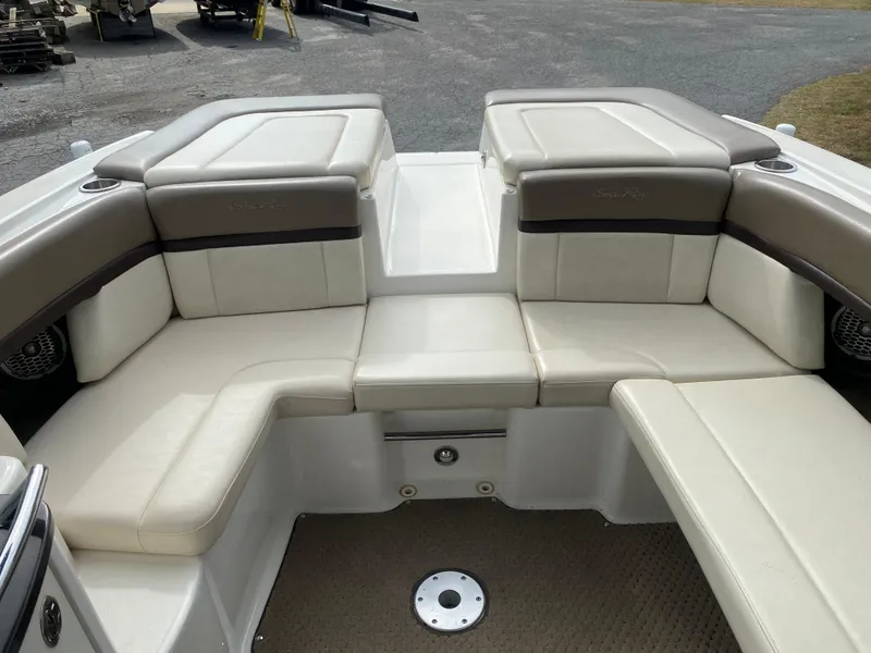 Slide: The Image of 2013 Sea Ray 270 SLX boat interior with beige seating and carpeted floor. - 14