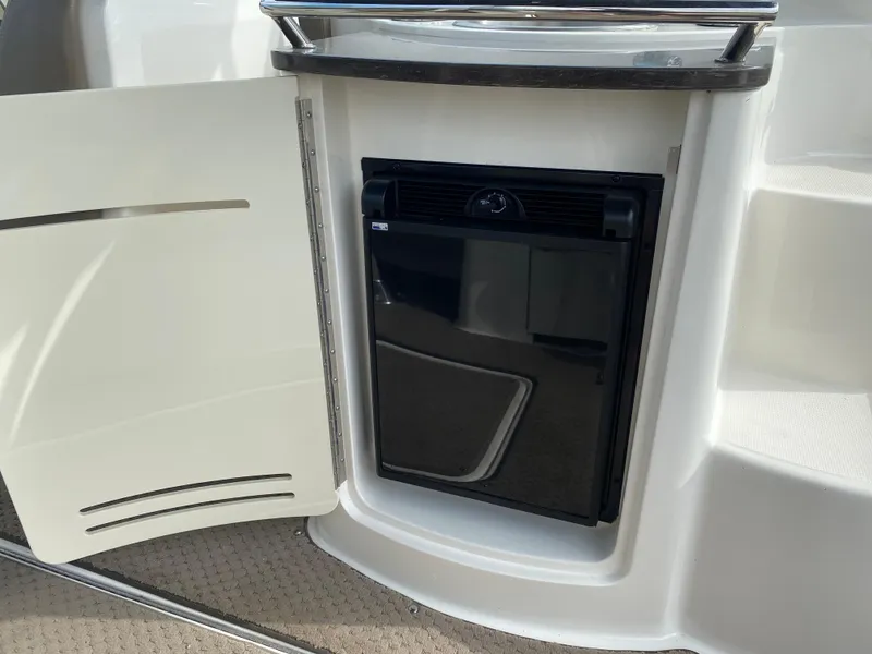Slide: The Image of 2013 Sea Ray 270 SLX boat interior with beige leather seating. - 15