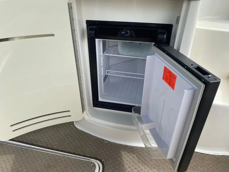 Slide: The Image of 2013 Sea Ray 270 SLX boat interior with built-in mini fridge. - 16