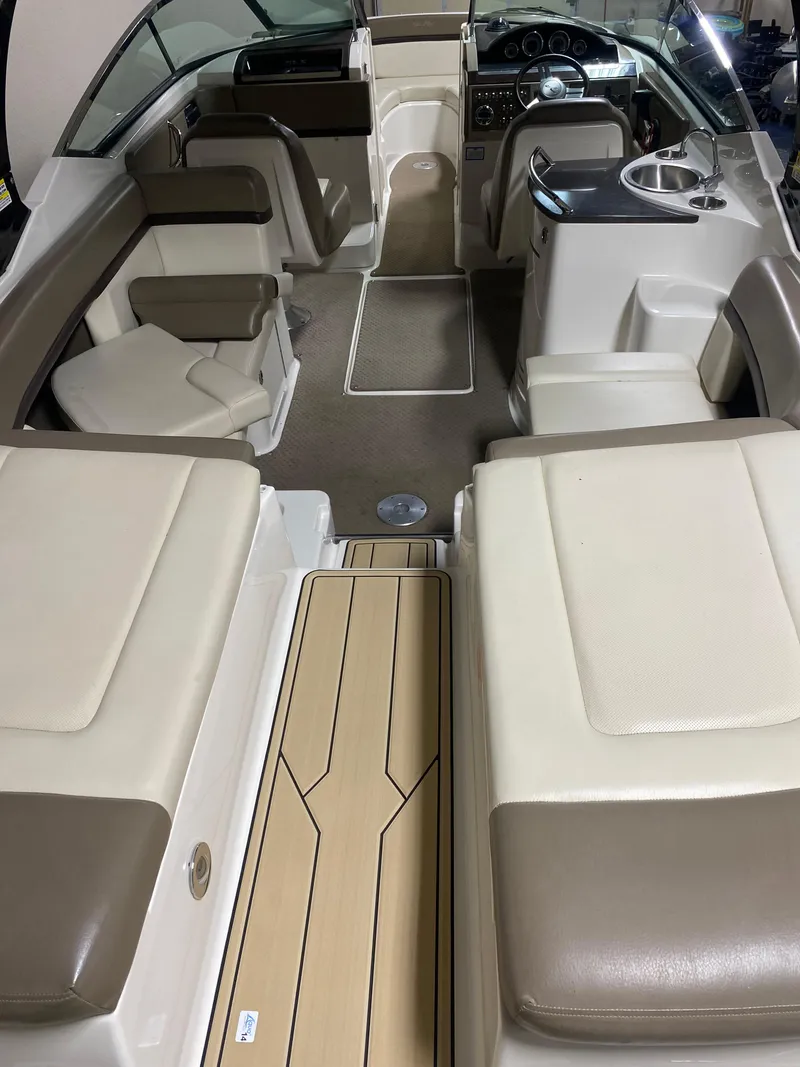 Slide: The Image of 2013 Sea Ray 270 SLX boat with tan deck and seating. - 5