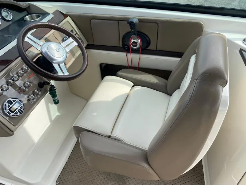 Slide: The Image of 2013 Sea Ray 270 SLX boat dashboard with steering wheel and control panel. - 8