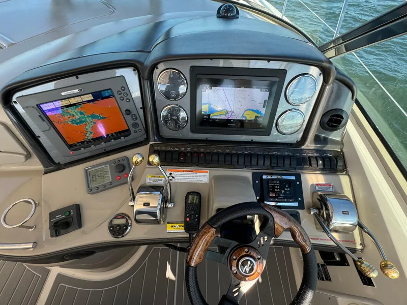 Slide: The Image of Control panel of 2007 Sea Ray 440 Sundancer with navigation screens and steering wheel. - 12