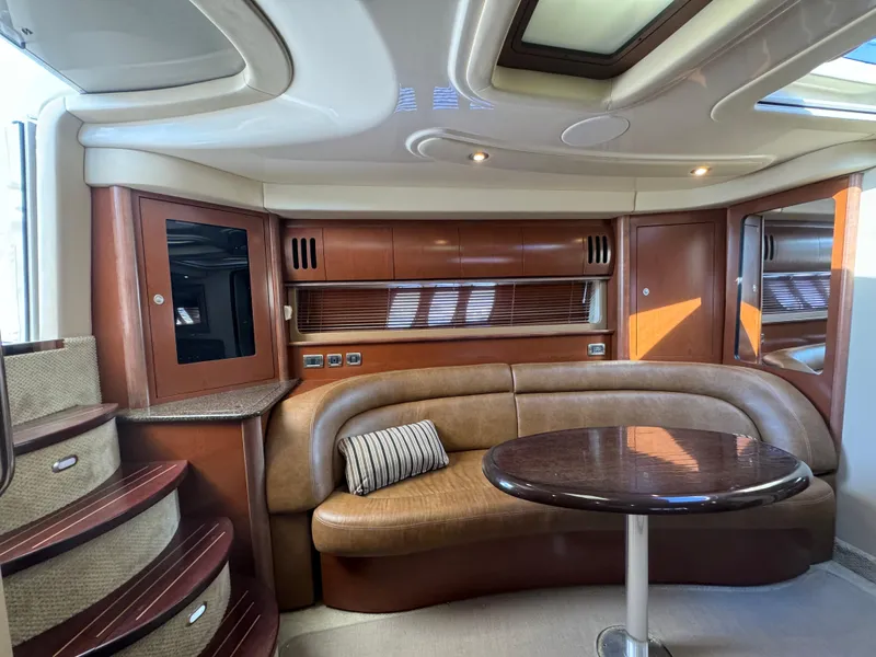 Slide: The Image of Luxurious 2007 Sea Ray 440 Sundancer yacht interior with elegant seating and table. - 14