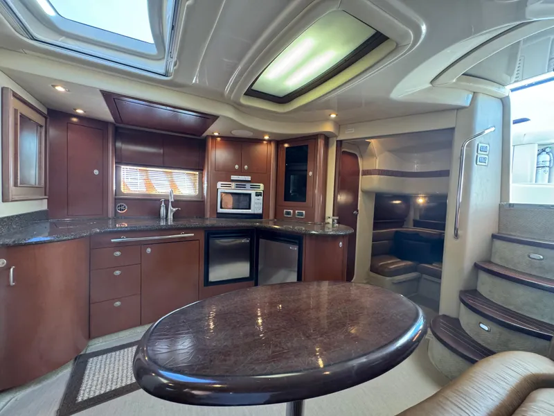 Slide: The Image of Luxurious interior of 2007 Sea Ray 440 Sundancer yacht with modern kitchen and seating area. - 15
