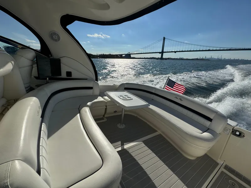 Slide: The Image of Luxurious 2007 Sea Ray 440 Sundancer cruising with bridge view and American flag. - 5