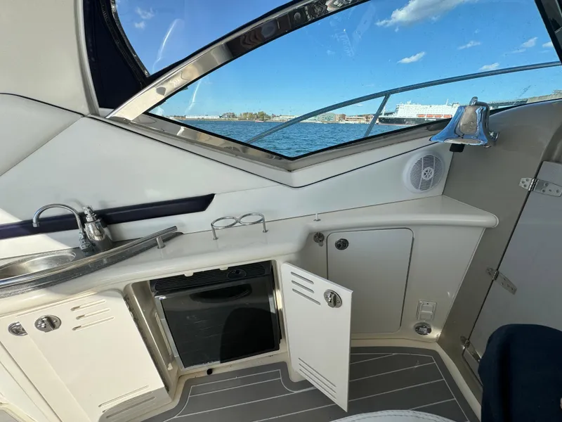 Slide: The Image of Interior of 2007 Sea Ray 440 Sundancer yacht with kitchenette and ocean view. - 9