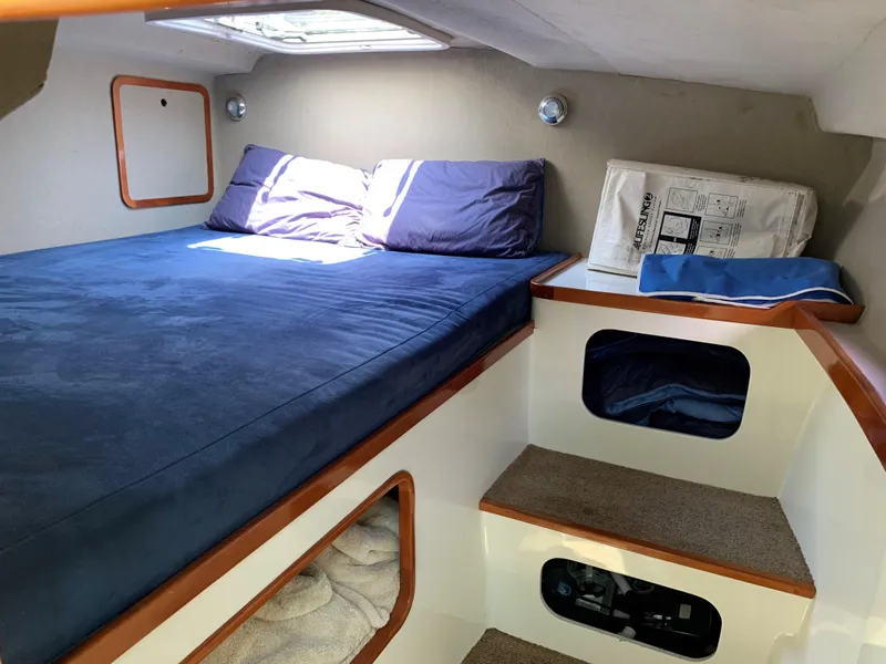 Slide: The Image of Cozy cabin interior of 2004 Roger Hill 9.5M boat with bed and storage. - 1