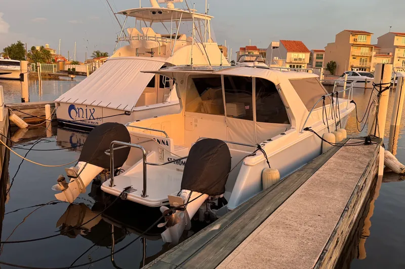 Slide: The Image of 2004 Roger Hill 9.5M boat docked at marina during sunset. - 14