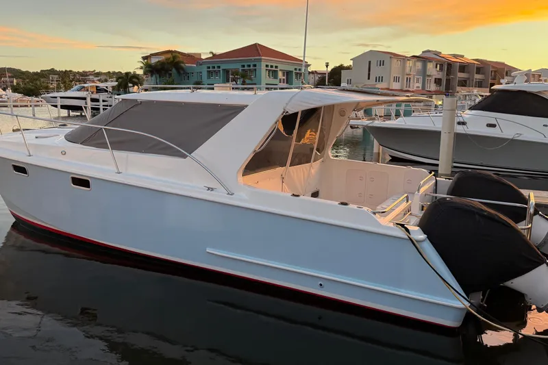 Slide: The Image of 2004 Roger Hill 9.5M boat docked at marina during sunset. - 15