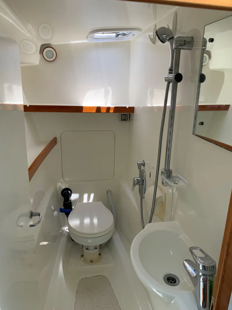 Slide: The Image of Compact bathroom in 2004 Roger Hill 9.5M boat with toilet, sink, and shower. - 3