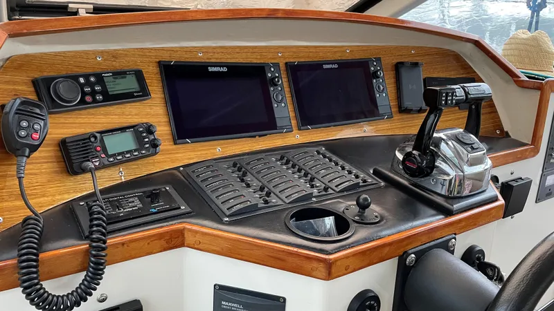 Slide: The Image of Control panel of a 2004 Roger Hill 9.5M boat with navigation screens and communication devices. - 6