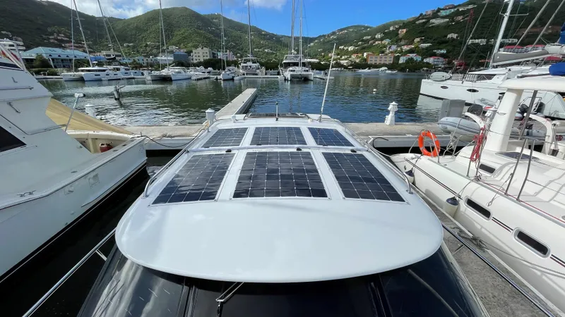 Slide: The Image of Roger Hill 9.5M 2004 boat with solar panels docked in a marina. - 8