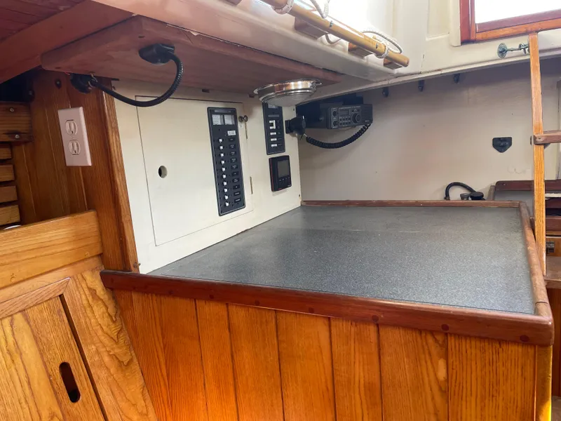 Slide: The Image of 1961 Sparkman & Stephens Pipe Dream Cruising Sloop interior with wooden cabinetry and electrical panel. - 15