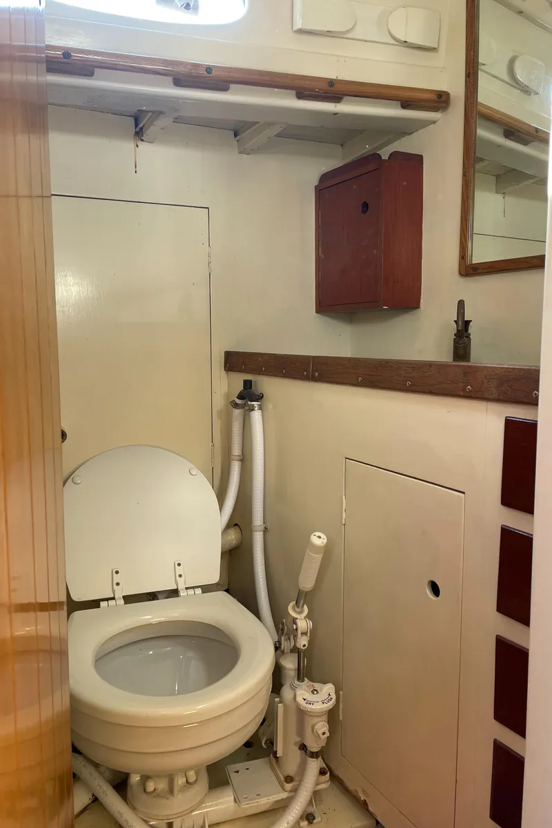 Slide: The Image of 1961 Sparkman & Stephens Pipe Dream Sloop bathroom with toilet and storage. - 16