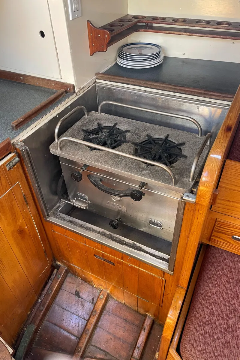 Slide: The Image of 1961 Sparkman & Stephens Pipe Dream Sloop galley with vintage stove and wooden cabinetry. - 20