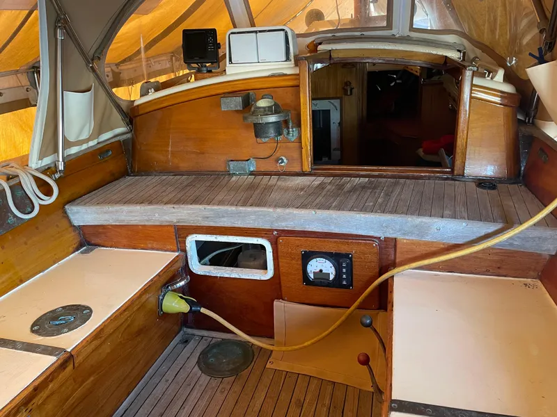Slide: The Image of 1961 Sparkman & Stephens Pipe Dream Cruising Sloop cockpit with wooden interior and navigation equipment. - 23