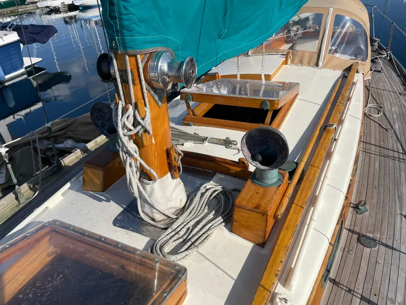 Slide: The Image of 1961 Sparkman & Stephens Pipe Dream Cruising Sloop deck with teal sail and wooden details. - 5