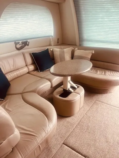 Slide: The Image of Luxurious interior of 1999 Maxum 4100 SCB yacht with plush seating and table. - 10