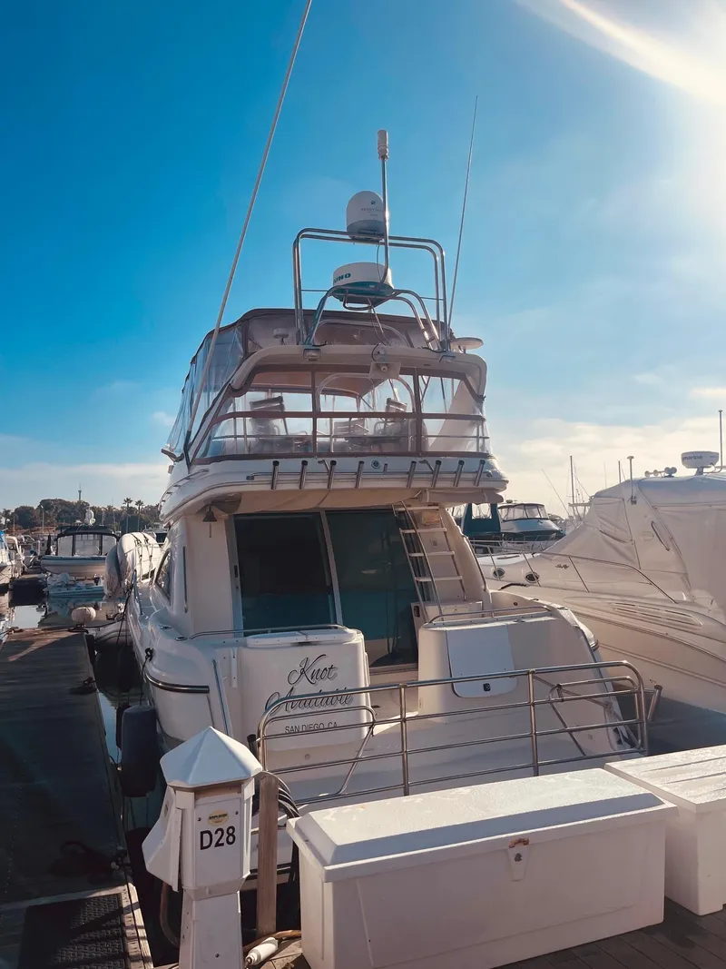 Slide: The Image of 1999 Maxum 4100 SCB yacht docked at marina under clear blue sky. - 12