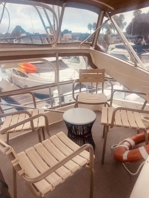 Slide: The Image of 1999 Maxum 4100 SCB yacht interior with seating area and marina view. - 3