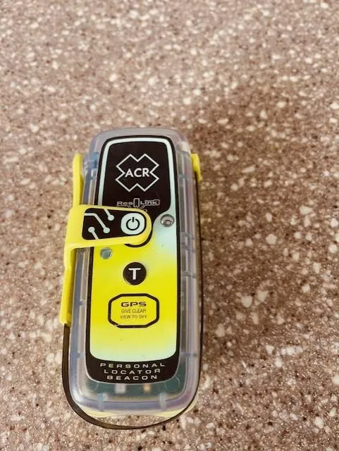 Slide: The Image of ACR personal locator beacon on speckled surface, Maxum 4100 SCB 1999 model. - 4