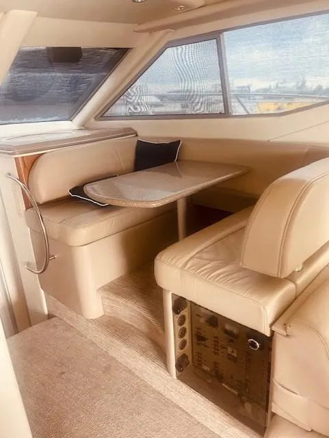 Slide: The Image of 1999 Maxum 4100 SCB yacht interior with beige seating and table. - 8