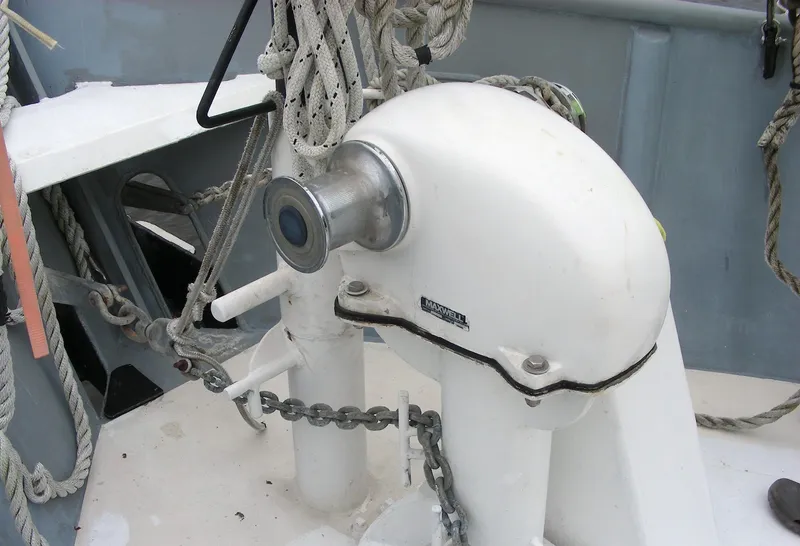 Slide: The Image of Custom 2000 Expedition boat docked near marshland, featuring a covered dinghy and equipment. - 12