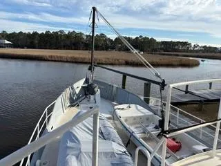 Slide: The Image of White winch on a 2000 Expedition custom boat deck with ropes and chains. - 13