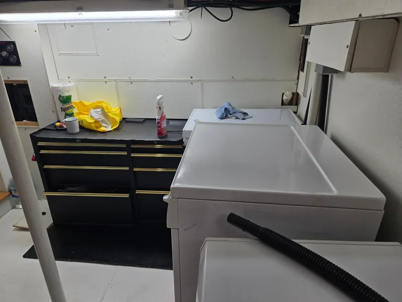 Slide: The Image of Utility room with electrical panel, storage cabinets, and appliances in a 2000 Expedition custom model. - 28