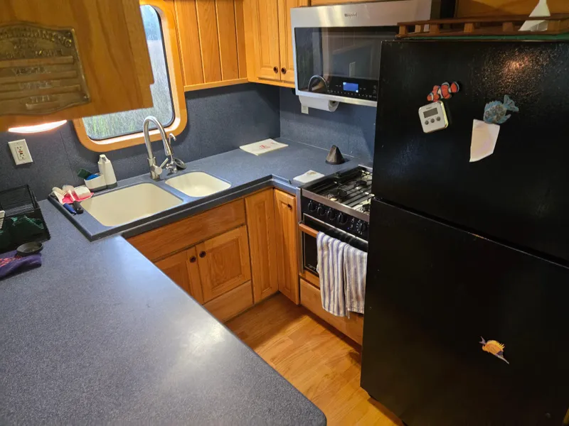 Slide: The Image of Cozy boat interior with blue leather seating, wooden paneling, and decorative pillows, Expedition custom 2000. - 35