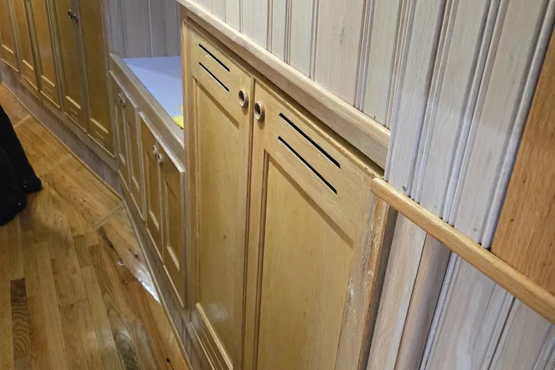 Slide: The Image of Interior of 2000 Expedition custom boat with wooden furnishings and blue seating. - 42