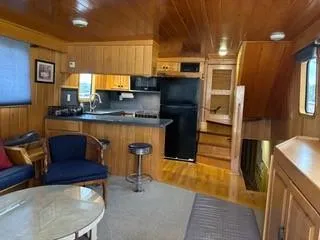Slide: The Image of Cozy seating area in 2000 Expedition custom boat with green cushions and decorative pillows. - 49