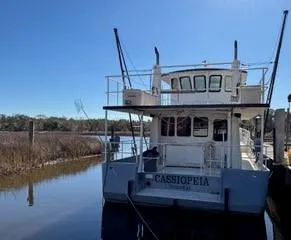 Slide: The Image of Exterior view of a 2000 Expedition custom boat with windows and a door. - 9