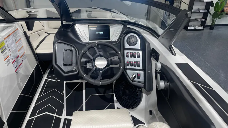 Slide: The Image of 2024 Supreme S220 boat dashboard with modern controls and sleek design. - 11