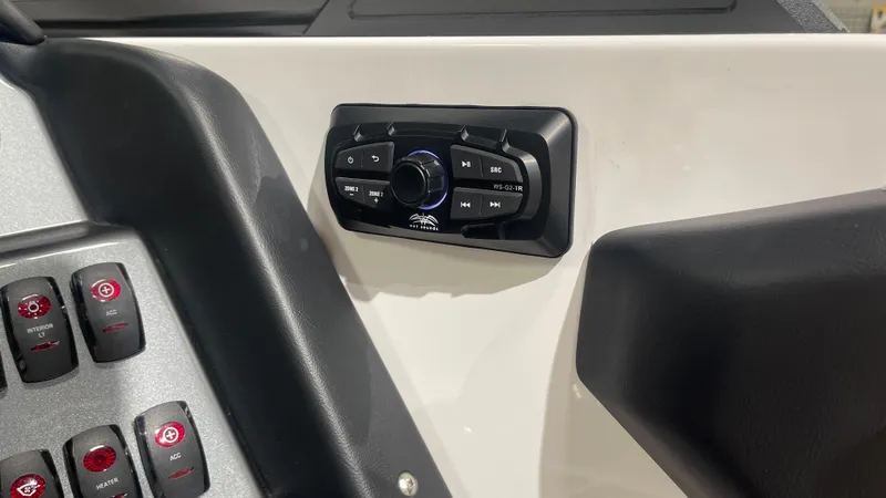 Slide: The Image of 2024 Supreme S220 boat dashboard with control panel and buttons. - 14