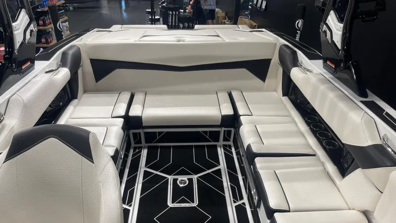 Slide: The Image of 2024 Supreme S220 boat interior with sleek white and black seating design. - 18