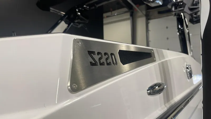 Slide: The Image of 2024 Supreme S220 boat, sleek white design with metallic branding. - 6