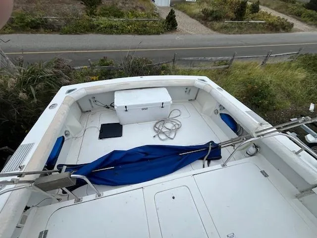 Slide: The Image of 1982 Bertram 28 Flybridge boat deck with storage and blue cover. - 4