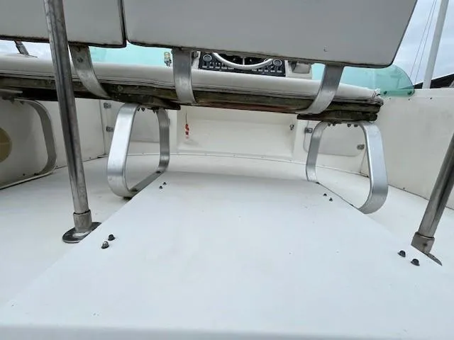 Slide: The Image of 1982 Bertram 28 Flybridge interior with seating and steering console. - 5