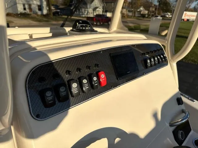Slide: The Image of 2025 Grady-White 231 Coastal Explorer dashboard with control panel and navigation instruments. - 10