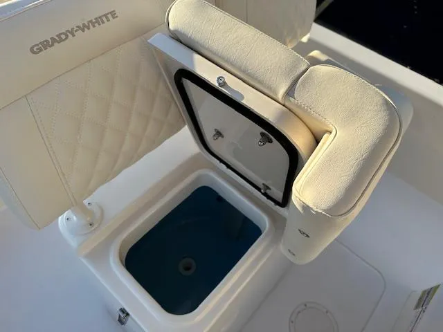 Slide: The Image of 2025 Grady-White 231 Coastal Explorer boat seat with storage compartment open. - 20