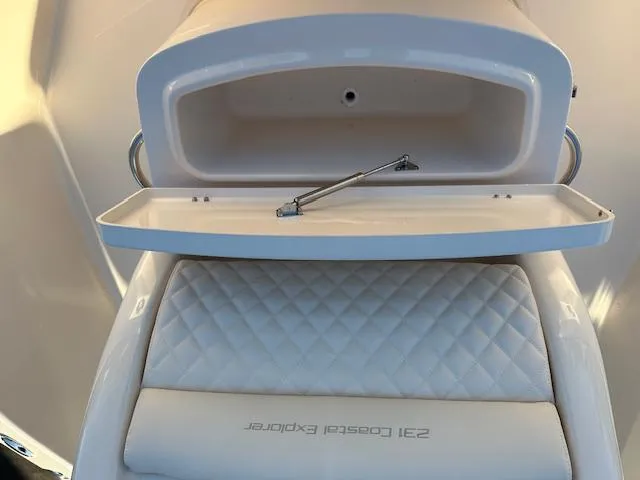 Slide: The Image of 2025 Grady-White 231 Coastal Explorer boat interior with open storage compartment. - 21