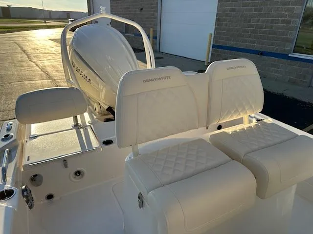 Slide: The Image of 2025 Grady-White 231 Coastal Explorer boat interior with cushioned seating and motor. - 25