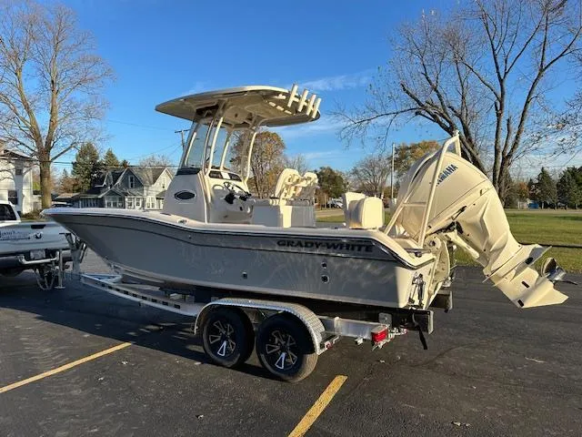 Slide: The Image of 2025 Grady-White 231 Coastal Explorer boat on trailer, parked outdoors. - 5