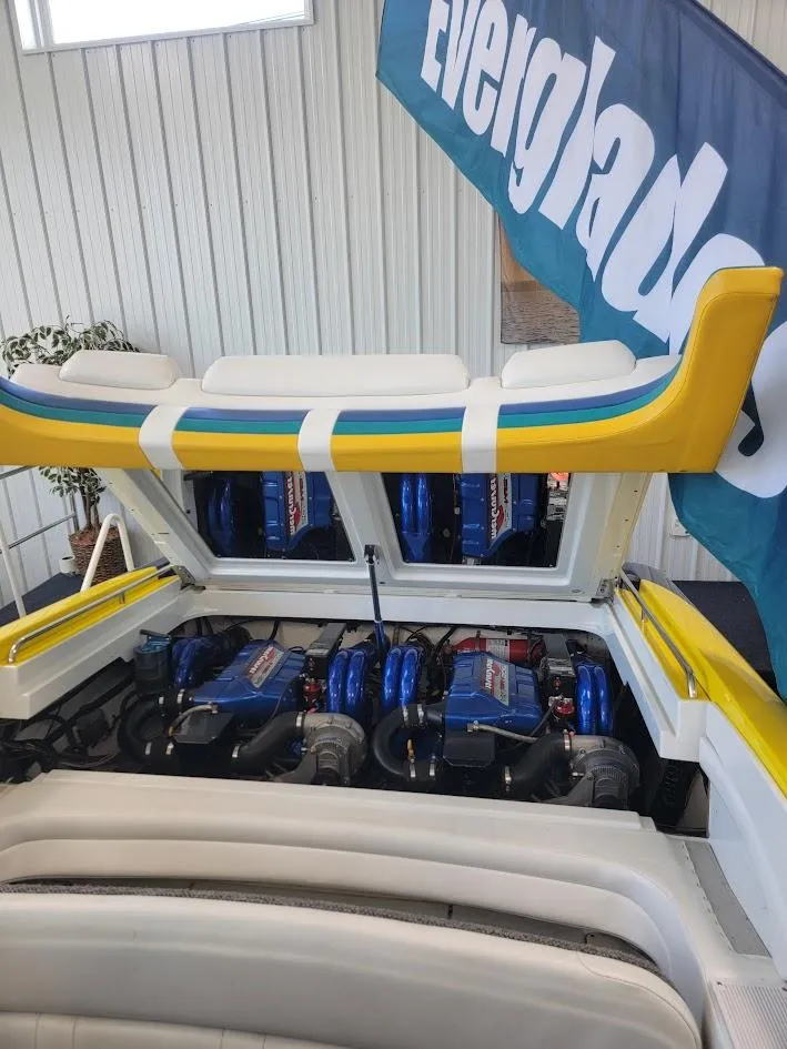 Slide: The Image of 1998 Formula 353 FASTech boat engine compartment with vibrant yellow and blue accents. - 1