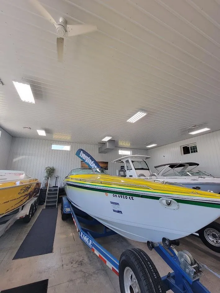 Slide: The Image of 1998 Formula 353 FASTech boat in a well-lit indoor storage facility. - 4